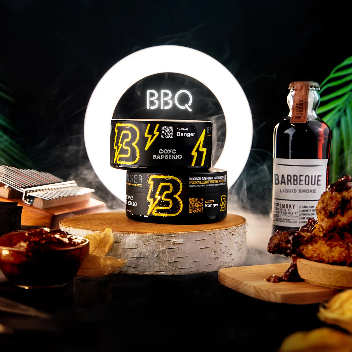 LE TABAC Banger BBQ sauce cans and barbeque liquid smoke bottle with grilled meat and dipping sauce