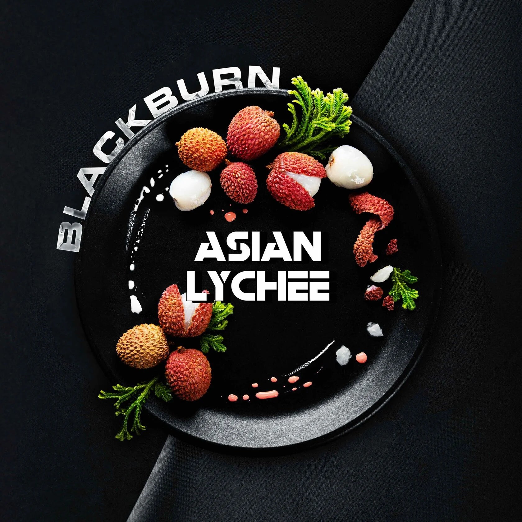 Blackburn Asian lychee fruit on black plate with green garnish and artistic sauce decoration