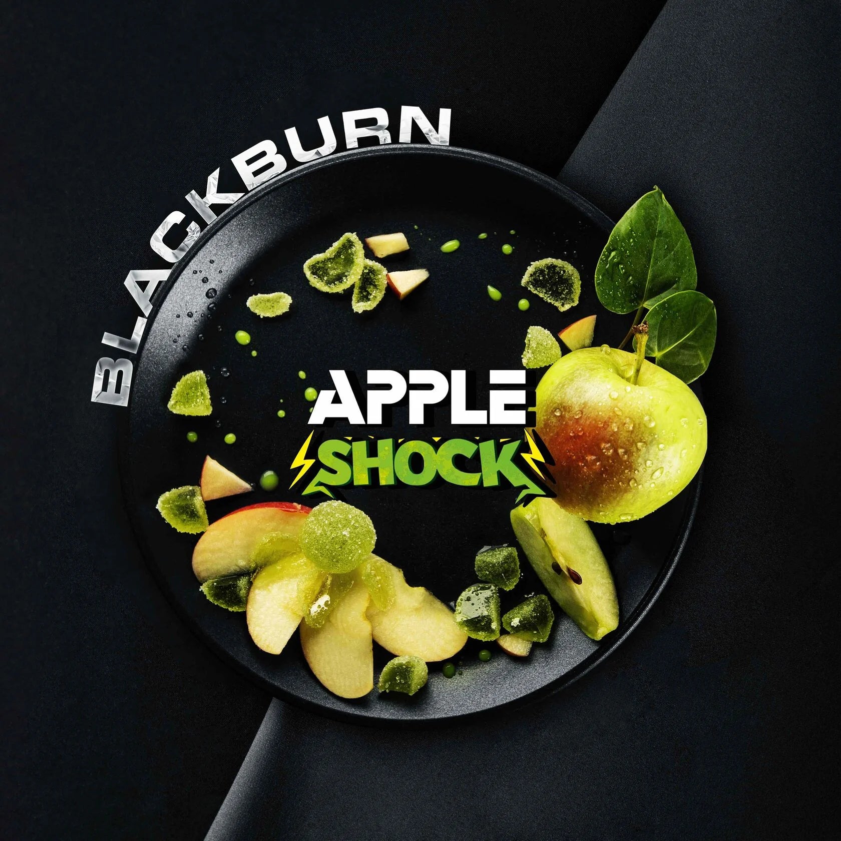Blackburn apple shock product with fresh green apple slices and green gummy pieces on a black plate