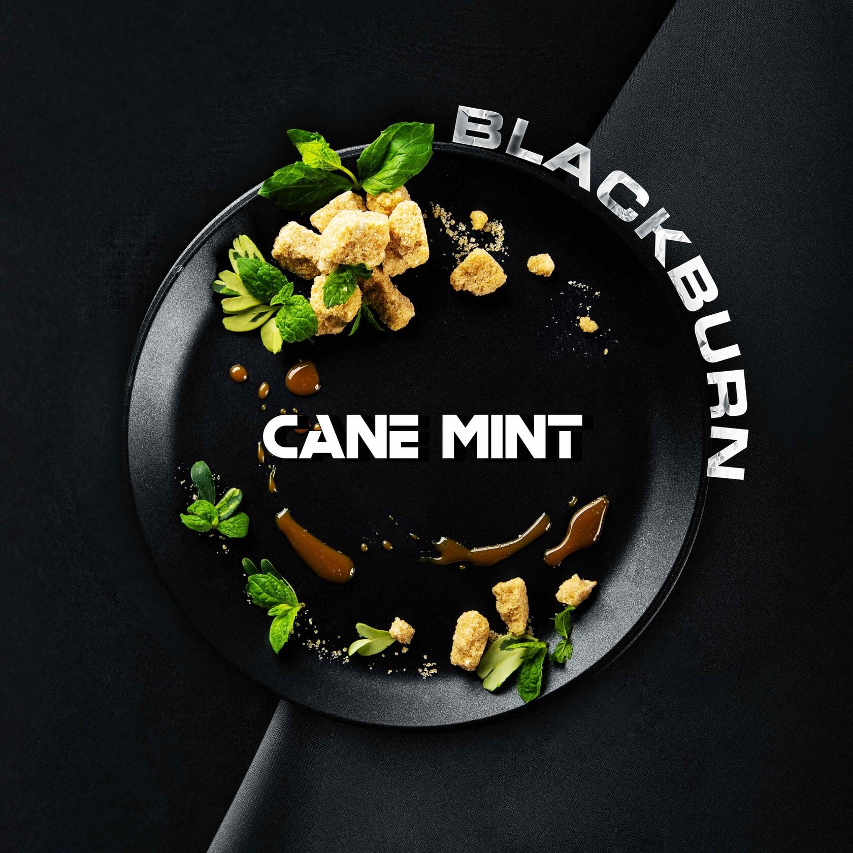 Blackburn cane mint flavor display with mint leaves and brown sugar pieces on black plate