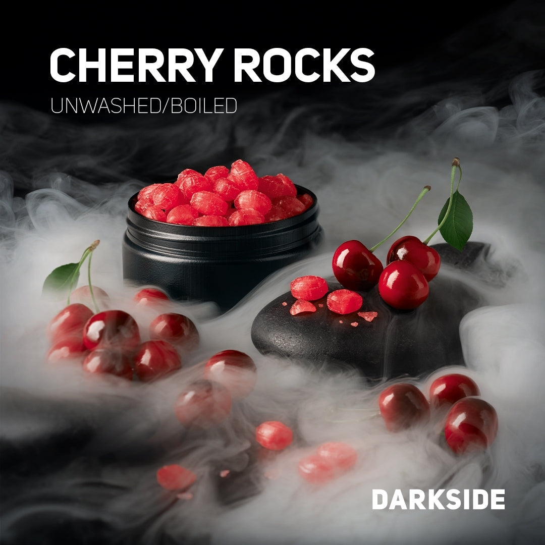 Cherry Rocks unwashed boiled tobacco pieces in black container surrounded by fresh cherries and smoke