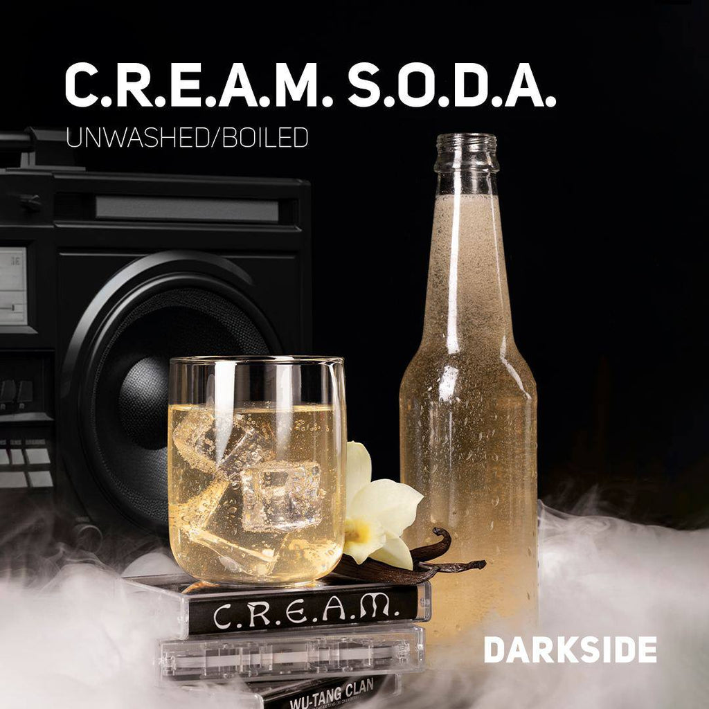 C.R.E.A.M. S.O.D.A. unwashed boiled flavored soda bottle and glass with ice cubes beside vintage cassette tapes and speaker