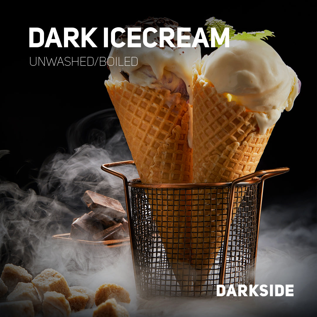 Dark ice cream scoops in waffle cones with mint garnish in a metal basket on smoky background
