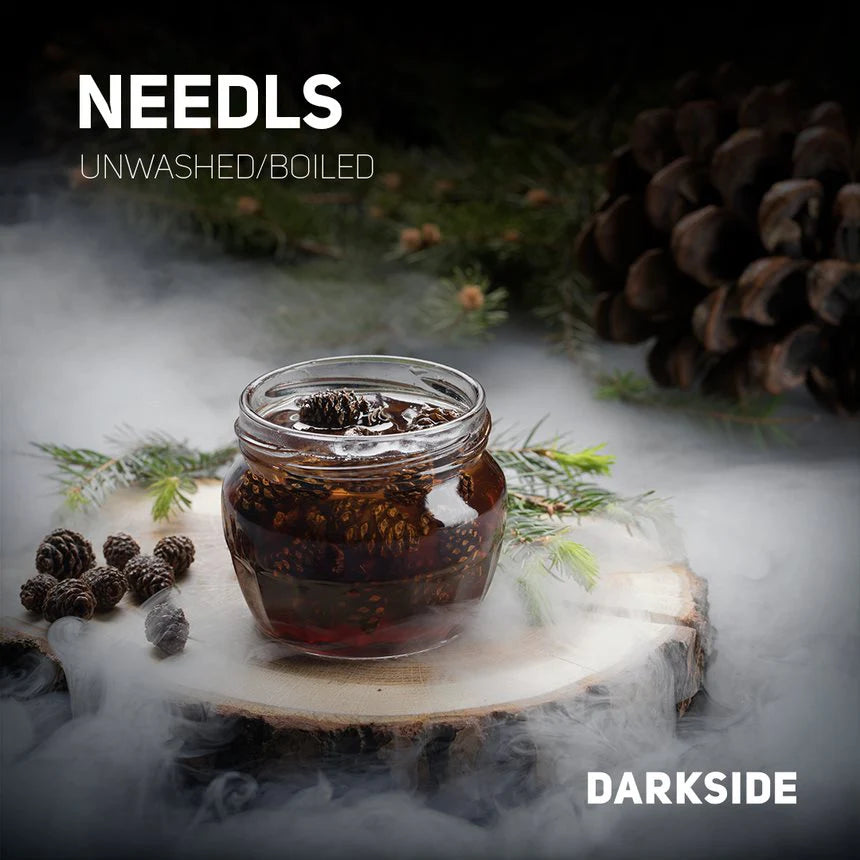 Glass jar of unwashed boiled needles surrounded by pine cones and smoke with LE TABAC branding