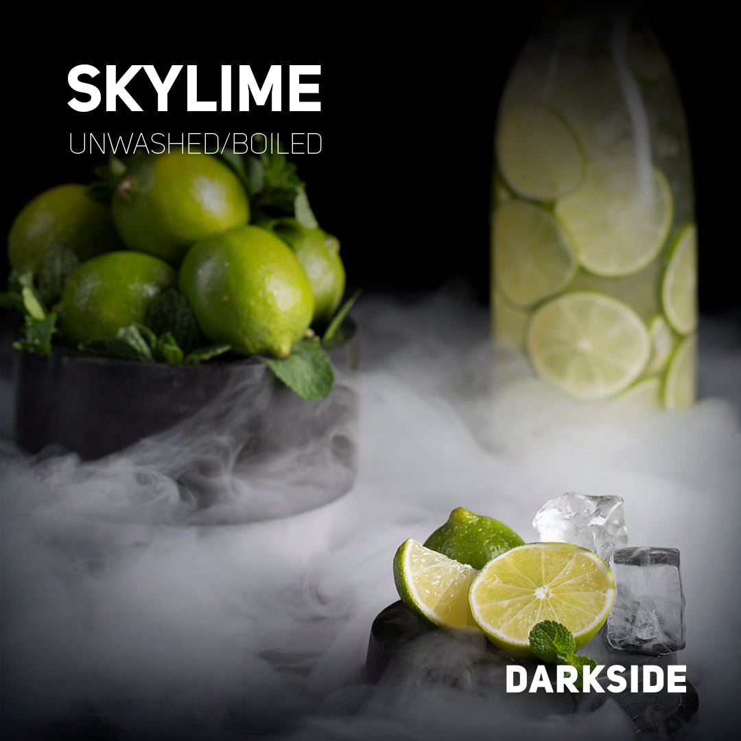 Fresh green skylime limes unwashed and boiled with ice cubes and mint leaves on a dark background