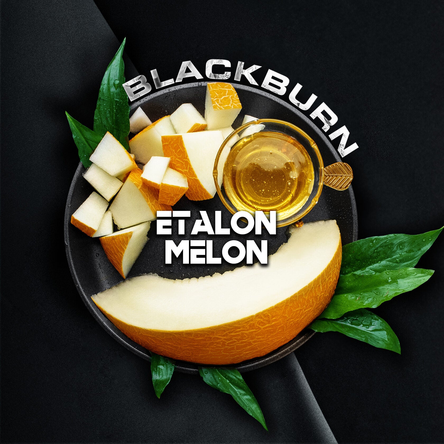 Blackburn Etalon melon slices on a black plate with honey and green leaves by LE TABAC